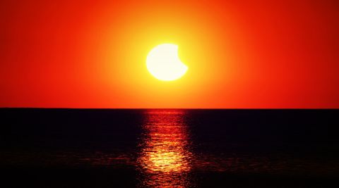 The solar eclipse illuminates the ocean in <a href="http://ireport.cnn.com/docs/DOC-1182916">New Port Richey, Florida</a>. 