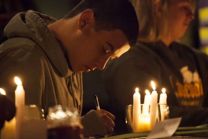 Students from Marysville-Pilchuck High School write messages and prayers during a vigil Friday, October 24, at a church in Marysville, Washington. Earlier in the day, <a href="index.php?page=&url=http%3A%2F%2Fwww.cnn.com%2F2014%2F10%2F27%2Fus%2Fwashington-school-shooting%2Findex.html">a student shot five people at the school</a> before he committed suicide, law enforcement officials told CNN.