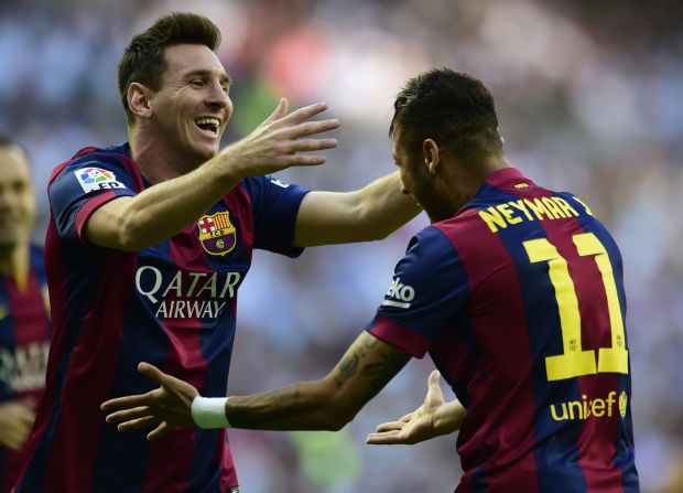 Lionel Messi (left) congratulates his teammate Neymar. The Brazilian striker opened the scoring for Barcelona in the 4th minute against Real Madrid at the Bernabeu on Saturday.
