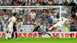 Karim Benzema (right) slides his shot past Cladio Bravo to score Real Madrid's third goal against Barcelona in Saturday's El Clasico.