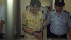 Sewol ferry captain Lee Joon-Seok (C) is escorted upon his arrival at the Gwangju District Court in the southwestern South Korean city of Gwangju on June 24, 2014.