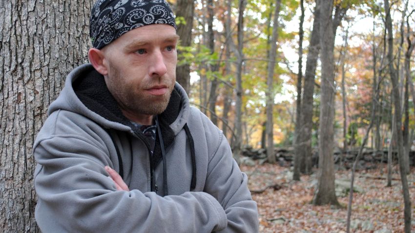 In this photo taken on Monday, Oct. 20, 2014, James Tully, of Canadensis, Pa., poses for a photo. The northeastern Pennsylvania man says he's been stopped at least 20 times by authorities who have mistaken him as Eric Frein, the suspect in a trooper's killing. Tully walks to work through the rural search area because he doesn't own a car. He also wears a backpack, an item police believe Frein has also carried. (AP Photo/Pocono Record, Beth Brelje) MANDATORY CREDIT