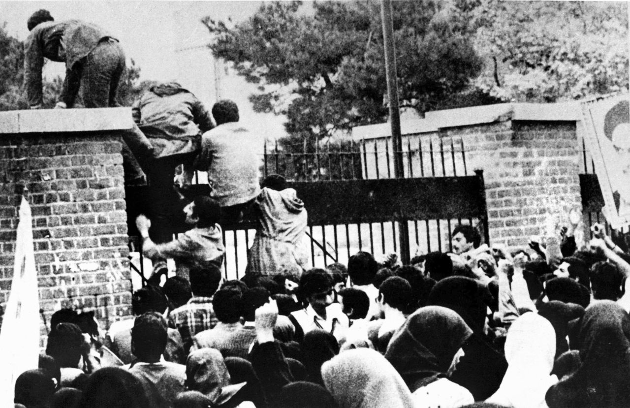 Iranian students climb over the wall of the U.S. Embassy in Tehran on November 4, 1979.