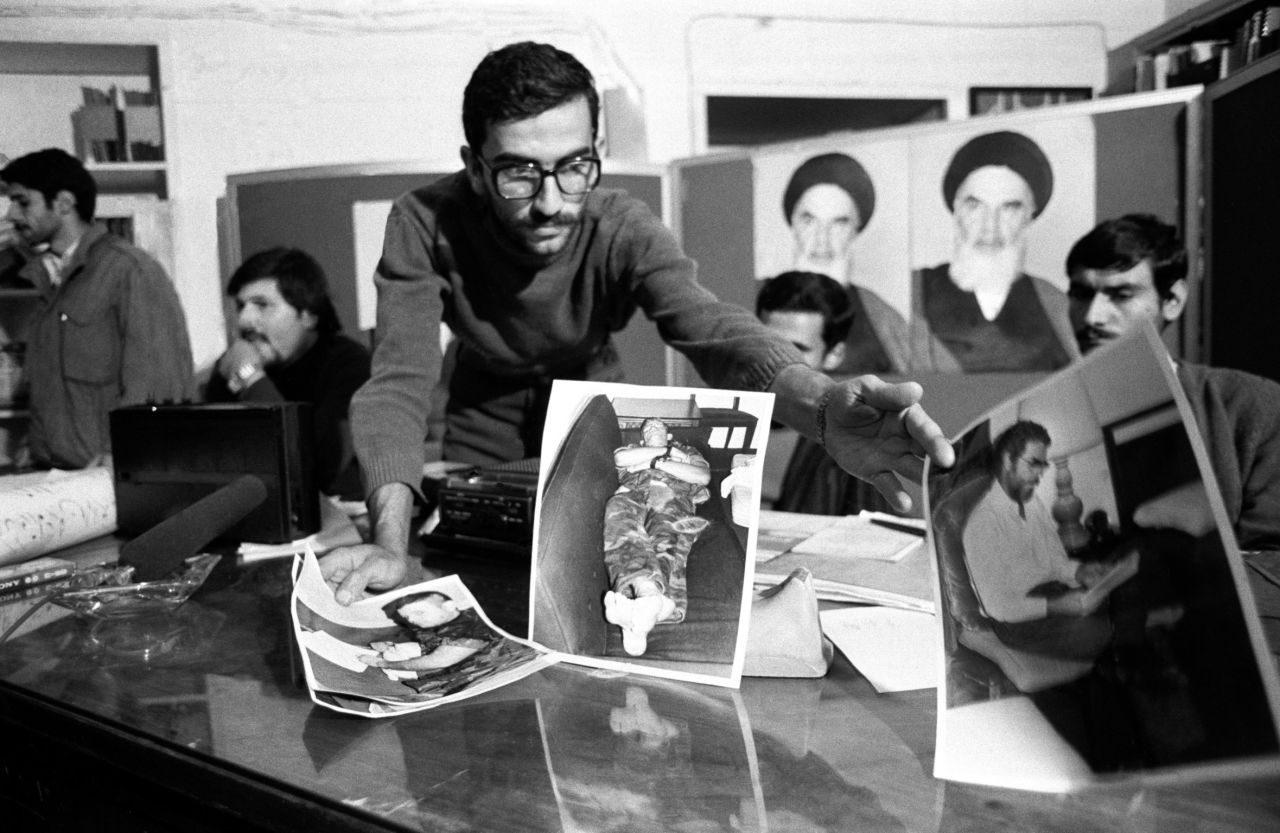 One of the student kidnappers presents pictures of the hostages during a news conference on November 8, 1979.