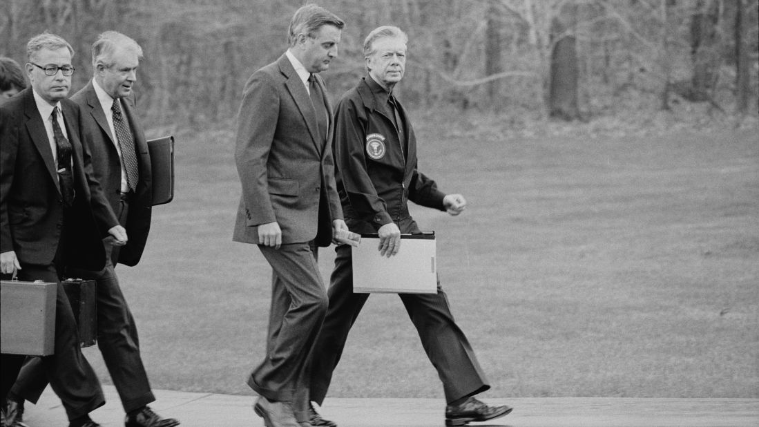 From right, President Jimmy Carter, Vice President Walter Mondale, Secretary of State Cyrus Vance and Secretary of Defense Harold Brown disembark from their helicopter to meet about the Iran hostage crisis at Camp David in Maryland on November 23, 1979. Carter ordered Iranian assets in U.S. banks frozen and eventually cut diplomatic ties with Iran.