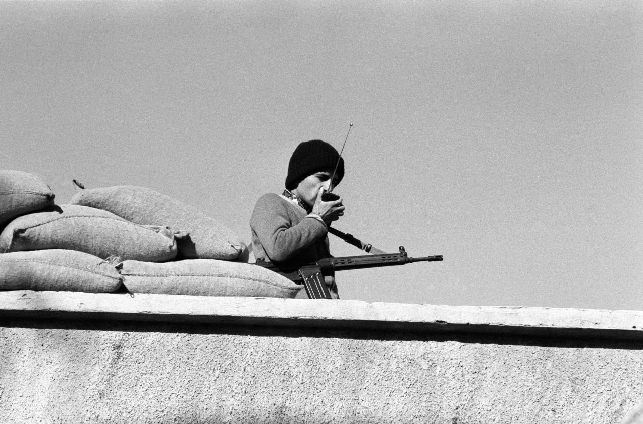 One of the kidnappers stands guard on the roof of the U.S. Embassy in Tehran on November 30, 1979.
