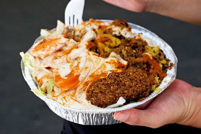 Halal carts slinging plates piled with falafel, shawarma and rice are ubiquitous in New York, but you'll recognize the <a href="index.php?page=&url=http%3A%2F%2Fwww.thekingfalafel.com" target="_blank" target="_blank">King of Falafel & Shawarma</a> by the seemingly endless line crowding the sidewalk beside it. 