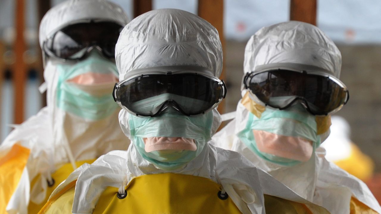 Health care workers, wearing protective suits, leave a high-risk area at the French NGO Medecins Sans Frontieres (Doctors without borders) Elwa hospital on August 30, 2014 in Monrovia. Liberia was hardest-hit by the Ebola virus when it raged through west Africa