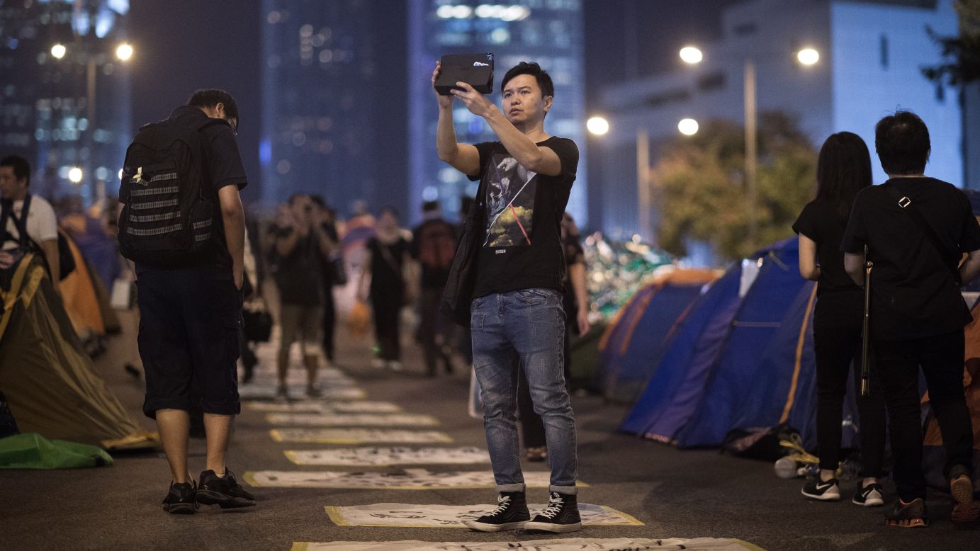 A man takes a selfie at a campsite for pro-democracy protesters in Hong Kong on Monday, October 27. <a href="http://www.cnn.com/2014/09/22/asia/gallery/hong-kong-students-protest/index.html">The protesters are angry</a> about China's decision to allow only Beijing-vetted candidates to run in Hong Kong's elections for chief executive in 2017.