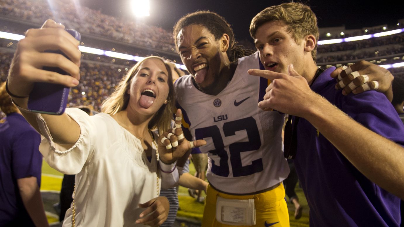 LSU cornerback Jalen Collins takes a selfie with fans Saturday, October 25, after the Tigers defeated Ole Miss 10-7 in Baton Rouge, Louisiana.