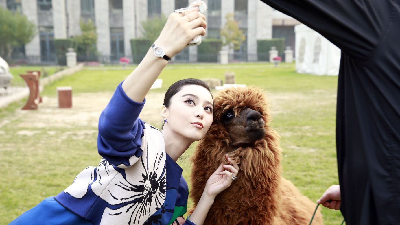 Actress Fan Bingbing takes a selfie with an alpaca Thursday, October 23, during a media event for the new movie "Skiptrace" in Beijing.