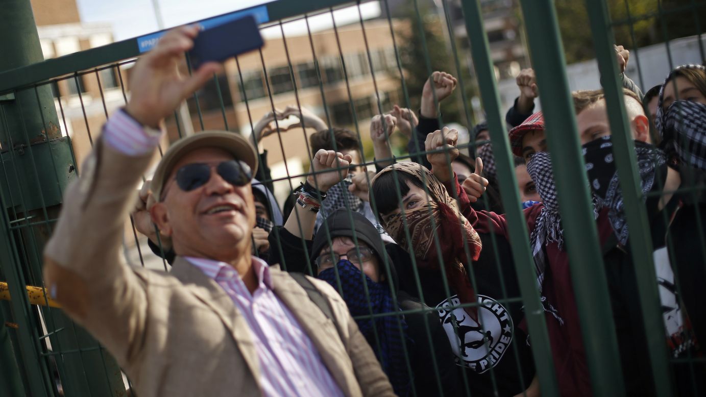 A man snaps a selfie in front of protesting students at the Complutense University of Madrid on Wednesday, October 22. It was the second day of a nationwide student strike against rising fees and educational cuts.