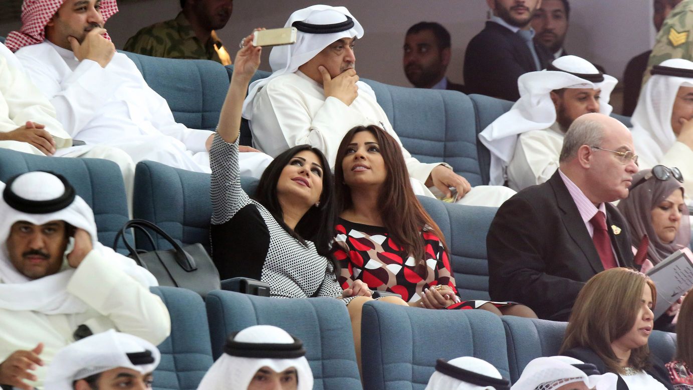 Two women take a selfie Tuesday, October 28, during the opening session of the new parliamentary term in Kuwait City.