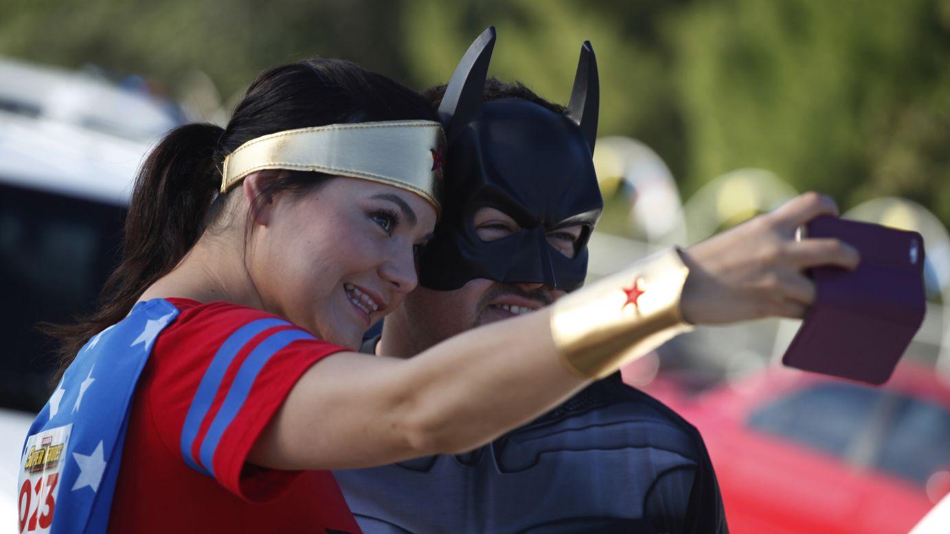 Runners dressed as comic book characters Wonder Woman and Batman take a selfie at a charity race in Ciudad Juarez, Mexico, on Sunday, October 26. The race raised money for children whose mothers are in jail. 