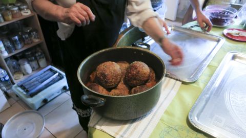 An Iranian family prepares a pot of stuffed kofta, or meatballs, for Bourdain.