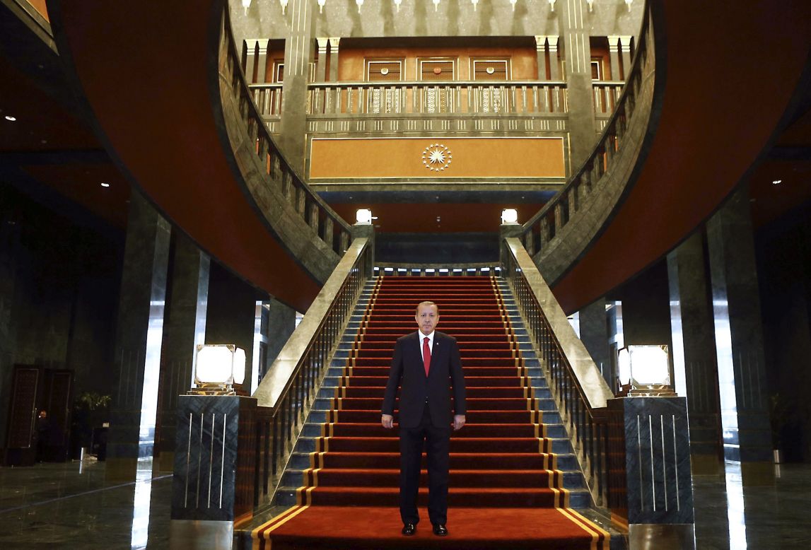 Turkish President Recep Tayyip Erdogan poses inside the new Ak Saray (White Palace) presidential palace on the outskirts of Ankara on October 29, 2014. He then hosted a reception marking the country's annual Republic Day, which celebrates the founding of modern Turkey in 1923. 