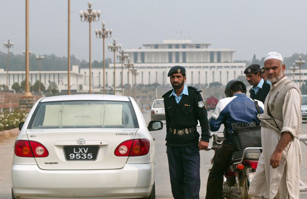 Pakistani police check a commuter's vehicle in front of the Aiwan-e-Sadr presidential palace in Islamabad on November 29, 2007. 