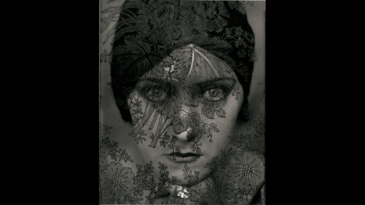 Actress Gloria Swanson in 1924, behind a laced veil.