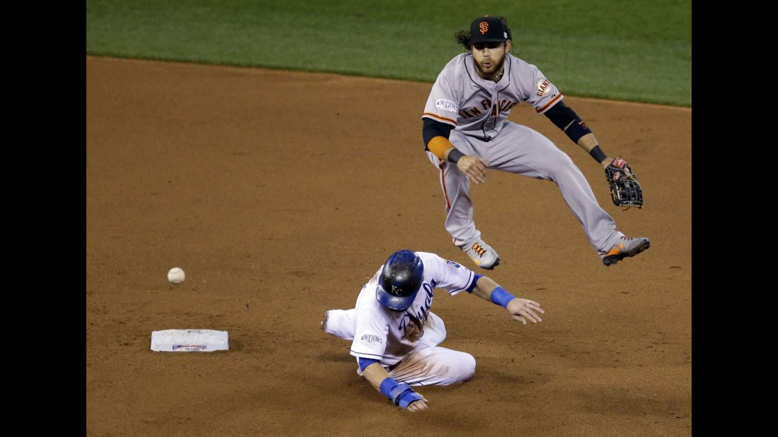 Kansas City Royals' Alex Gordon is out at second as Brandon Crawford of the San Francisco Giants turns a double play on a ball hit by Salvador Perez during the fourth inning of Game 7 of the World Series on  October 29, in Kansas City, Missouri.