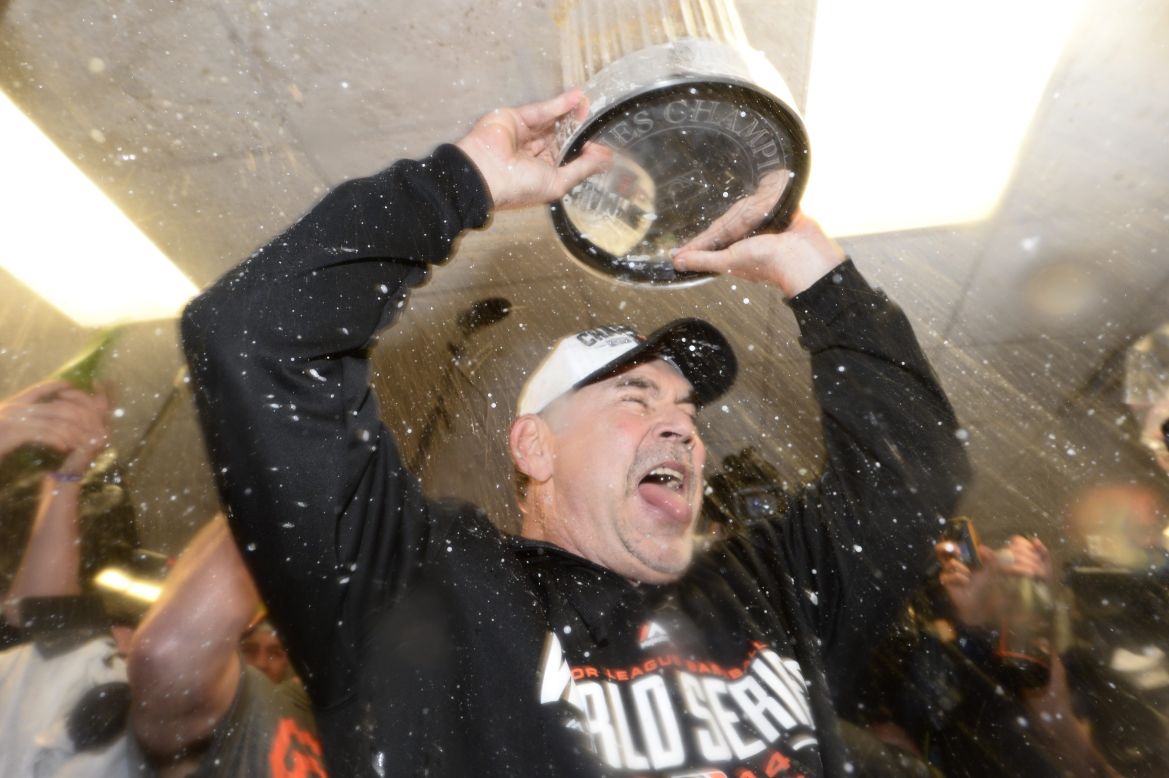 San Francisco Giants manager Bruce Bochy celebrates with the World Series trophy after defeating the Kansas City Royals 3-2 in Game 7 of the World Series at Kauffman Stadium in Kansas City, Missouri, on October 29.