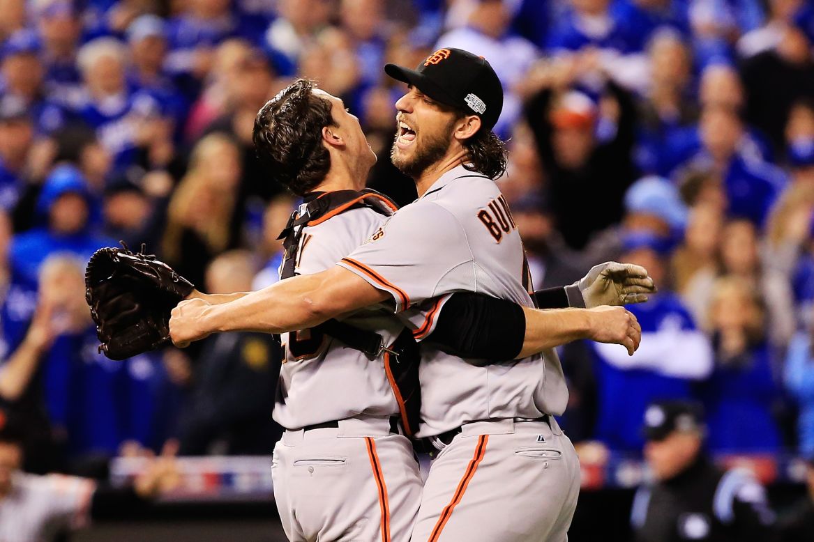 San Francisco Giants players Buster Posey, left, and Madison Bumgarner celebrate after defeating the Kansas City Royals 3-2 to win Game 7 of the 2014 World Series at Kauffman Stadium on October 29 in Kansas City, Missouri.  Bumgarner was the series MVP.