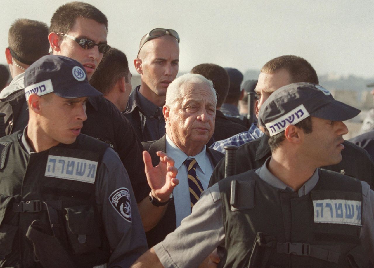Ariel Sharon, then a candidate for Israeli prime minister, is flanked by security guards as he leaves the al-Aqsa Mosque compound in September 2000. The Second Intifada, a five-year Palestinian uprising, was sparked by Sharon's visit, Palestinians say. Sharon insisted that his visit was not intended to provoke Palestinians, but many saw it as an attempt to underline Israel's claim to Jerusalem's holy sites.