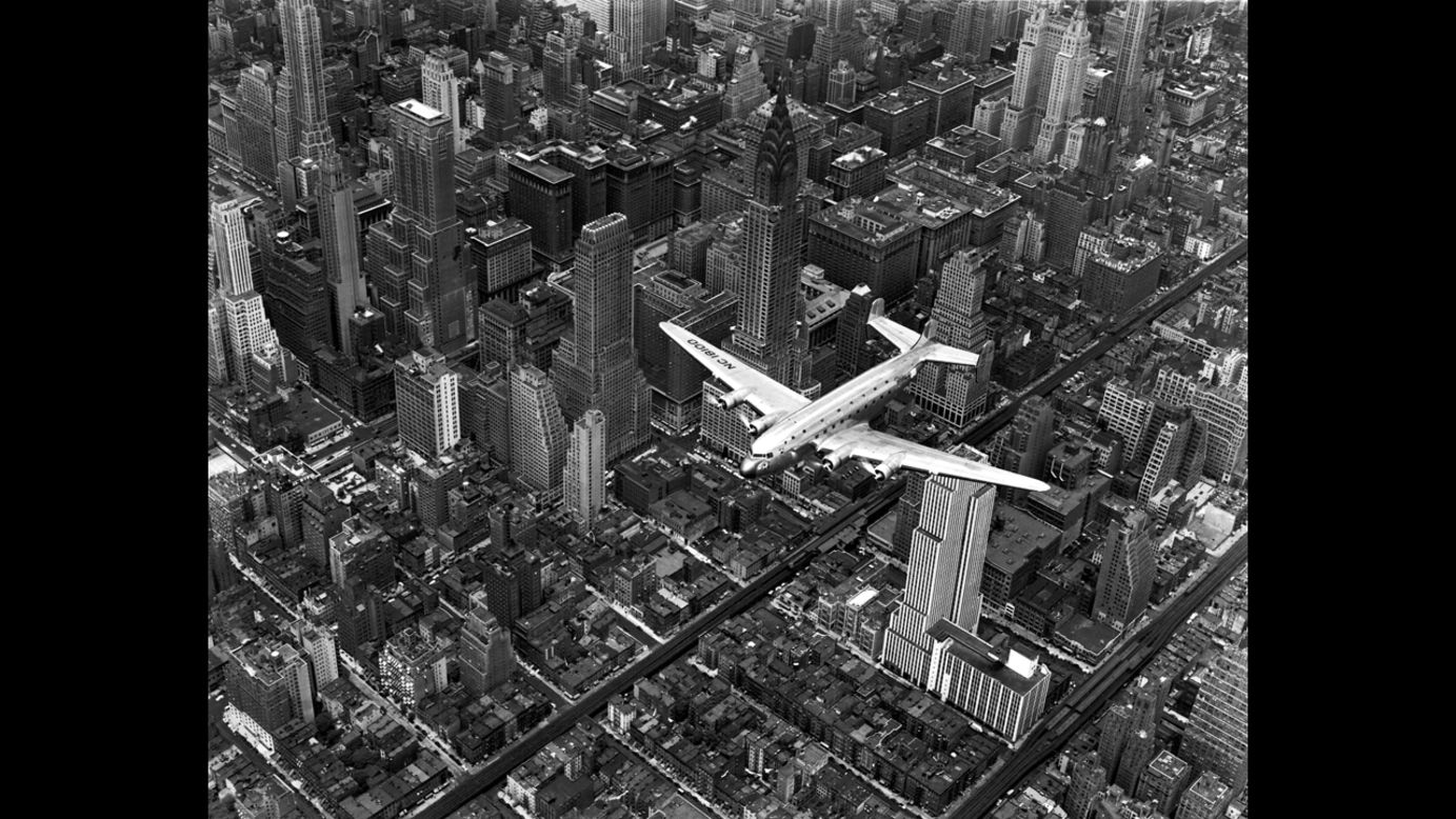 Life magazine photographer Margaret Bourke-White snapped this photo showing a DC-4 passenger plane flying over midtown Manhattan in 1939.