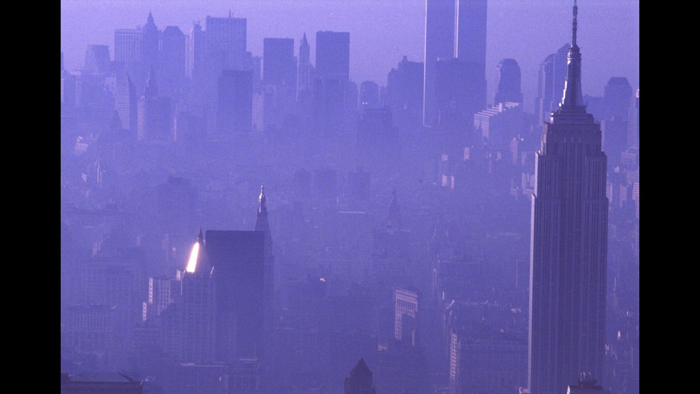A purple haze enshrouds the city in 1989, with the Empire State Building in the foreground and the Twin Towers in the background.