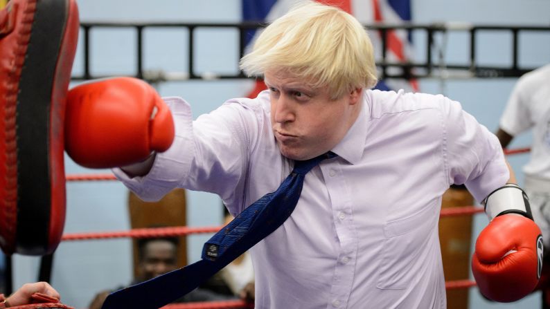 London Mayor Boris Johnson punches a pad Tuesday, October 28, during a visit to the Fight for Peace Academy in the UK capital. Fight for Peace uses boxing and martial arts, combined with education and personal development, to help at-risk youth realize their potential.