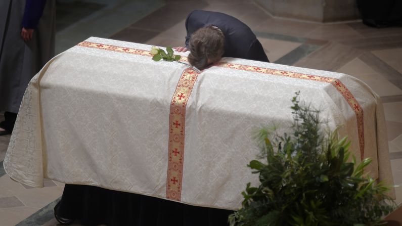 Quinn Bradlee, son of former Washington Post Executive Editor Ben Bradlee, rests his head on his father's casket during memorial services at the Washington National Cathedral on Wednesday, October 29. Ben Bradlee, <a href="http://www.cnn.com/2014/10/21/us/gallery/ben-bradlee/index.html">who guided the newspaper through the era of the Pentagon Papers and Watergate</a> and was immortalized on screen in "All the President's Men," died on October 21. He was 93.