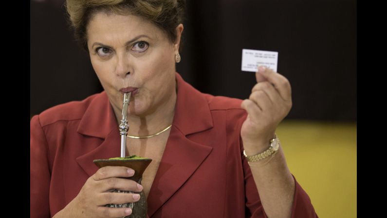 Brazilian President Dilma Rousseff drinks mate, an herbal tea, and shows an electronic voting receipt that confirms she voted in the presidential runoff Sunday, October 26. Rousseff held off challenger Aecio Neves <a href="http://www.cnn.com/2014/10/26/world/americas/brazil-presidential-election/index.html">to win re-election.</a>