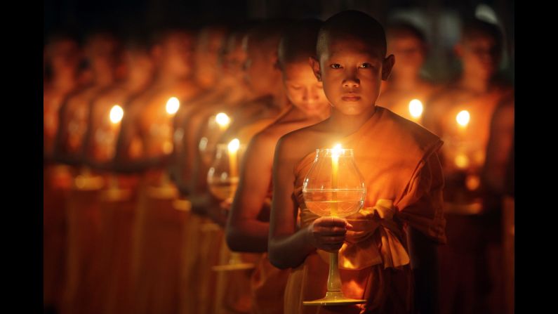 Young Buddhist monks hold candles during the Yi Peng festival Saturday, October 25, in Chiang Mai, Thailand.