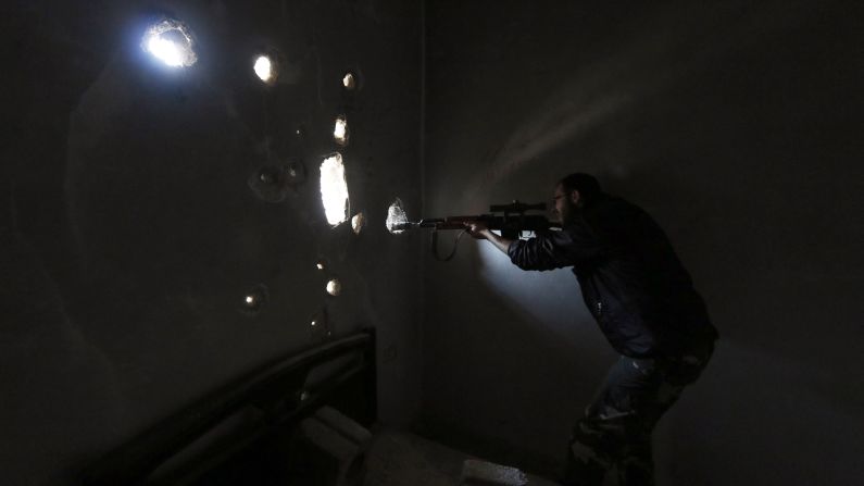 A Free Syrian Army fighter aims his gun through the wall of a damaged building in Aleppo, Syria, on Sunday, October 26. The United Nations estimates more than 190,000 people have been killed in Syria since an uprising in March 2011 <a href="http://www.cnn.com/2014/02/10/middleeast/gallery/syria-unrest-2014/index.html">spiraled into civil war.</a>