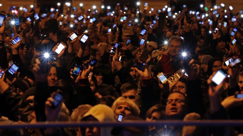 People in Budapest, Hungary, hold up their cell phones Sunday, October 26, as they protest a new tax on Internet data transfers. <a href="http://www.cnn.com/2014/10/24/world/gallery/week-in-photos-1024/index.html">See last week in 37 photos</a>