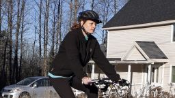 Nurse Kaci Hickox leaves her home on a rural road in Fort Kent, Maine, to take a bike ride with her boyfriend Ted Wilbur, Thursday, Oct. 30, 2014. The couple went on an hour-long ride followed by a Maine State Trooper. State officials are going to court to keep Hickox in quarantine for the remainder of the 21-day incubation period for Ebola that ends on Nov. 10. Police are monitoring her, but can't detain her without a court order signed by a judge. (AP Photo/Robert F. Bukaty)
