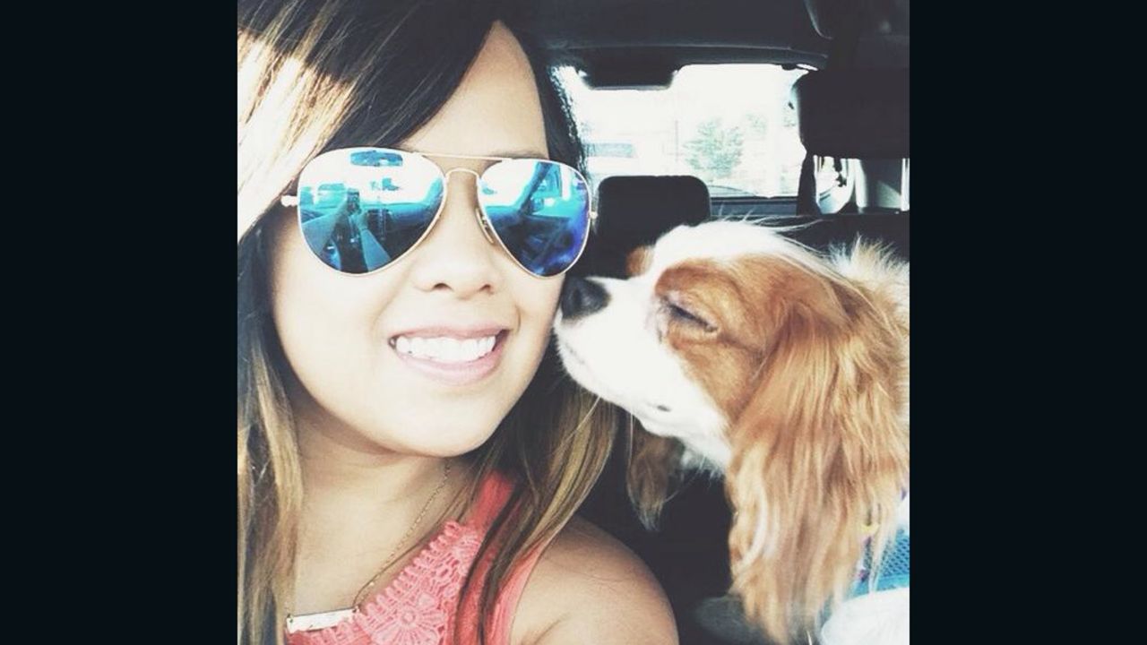 Nina Pham rides with her dog, Bentley, as seen in this photo from Facebook. After Pham's treatment for Ebola and Bentley's quarantine, the two will be reunited Saturday.
