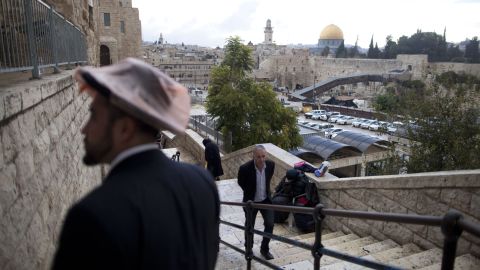 Israelis walk at the Jewish quarter in the Old City overlooking the Temple Mount on October 31.