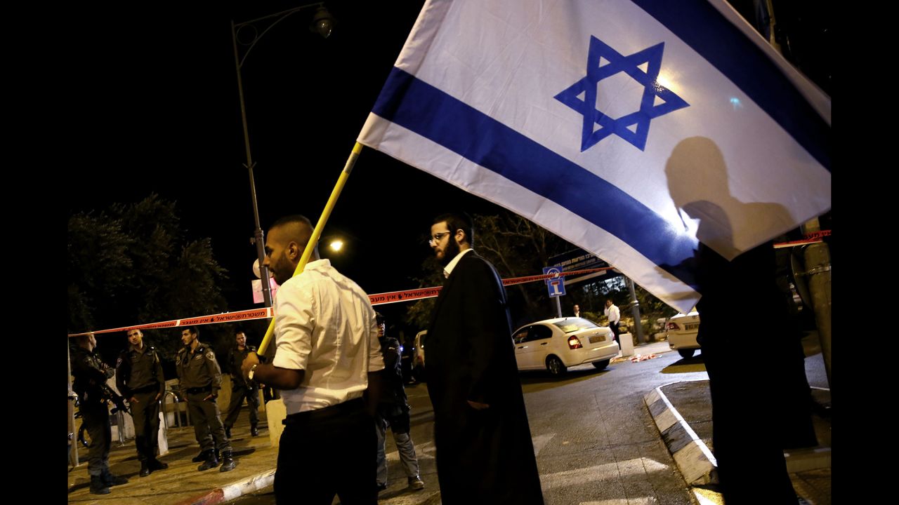Israeli demonstrators wave flags outside the Menachem Begin Heritage Center, where Glick was shot in Jerusalem on October 29.