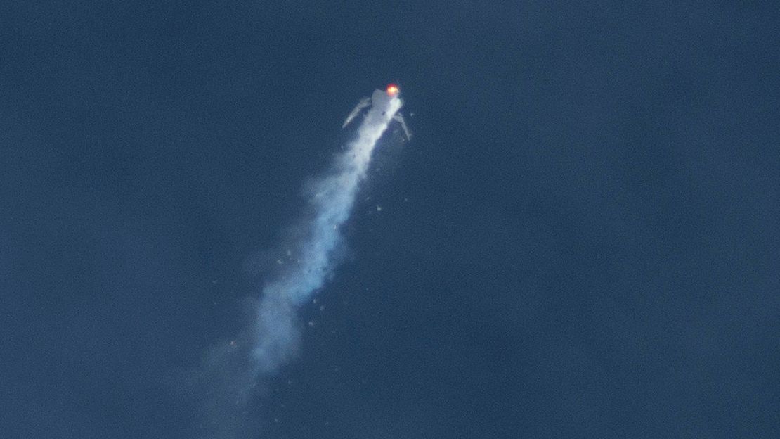 The Virgin Galactic SpaceShipTwo rocket explodes in the air during a test flight on Friday, Oct. 31, 2014. The explosion killed a pilot aboard and seriously injured another while scattering wreckage in the Mojave Desert.