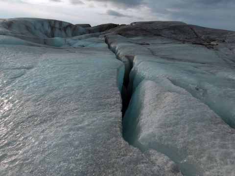 Crevasses opened up by friction as the ice moves down the mountain can penetrate to the bottom of the glacier -- at this point up to 50 meters deep. Further up, the glacier can be up to a kilometer deep.