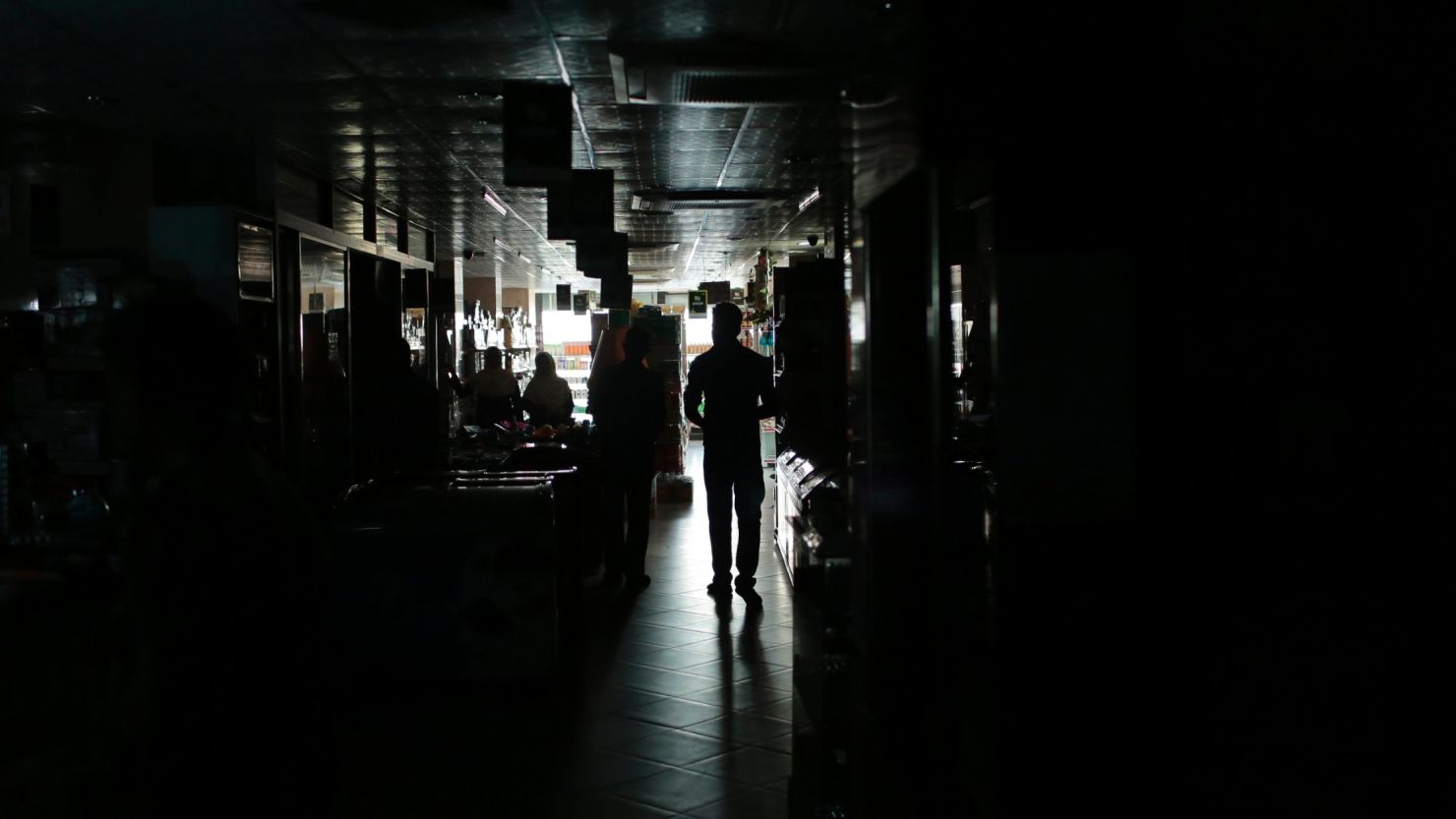 A Bangladeshi man walks in a shopping mall during a blackout in Dhaka, Bangladesh.