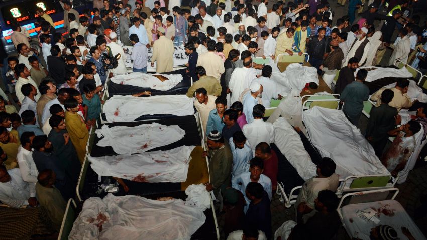 Pakistani relatives gather around the bodies of blast victims after a suicide bomb attack Sunday near the Pakistan-India border. 