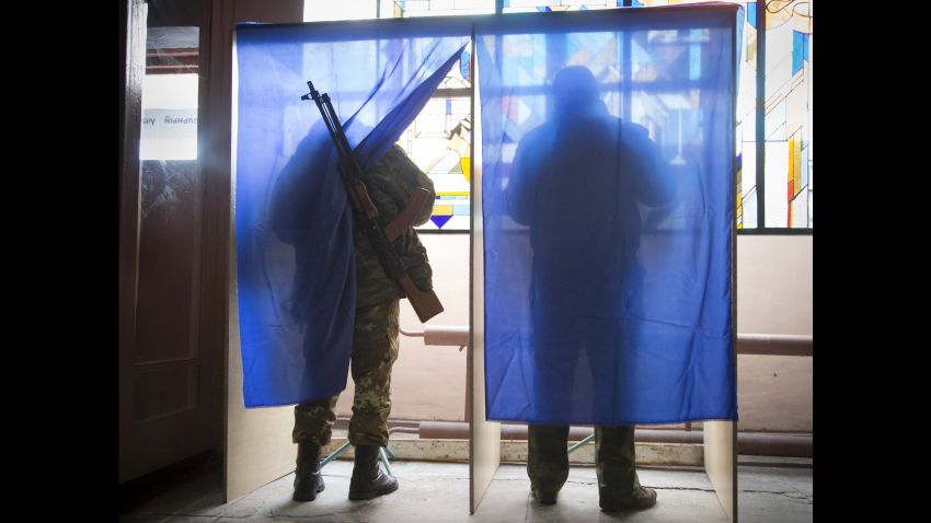 Pro-Russian rebels fill their ballots at a polling station during rebel elections in the city of Donetsk, Ukraine, on Sunday, November 2.
