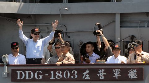 Taiwan's President Ma Ying-Jeou, left, waves from a warship during naval drills at sea on September 17.