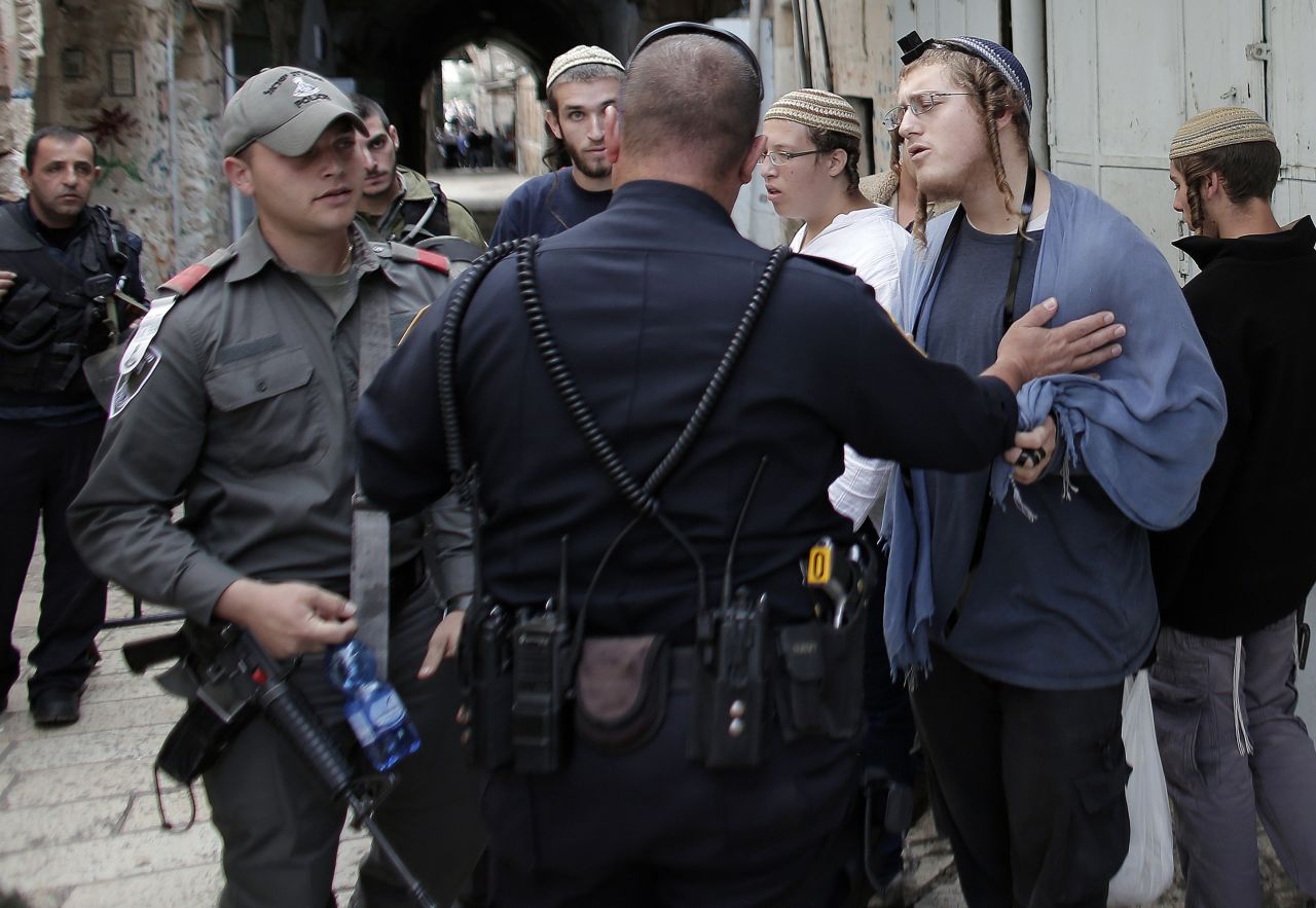 Right-wing Israelis are stopped by Israeli policemen as they try to access the al-Aqsa Mosque compound, part of the Temple Mount, on November 2. <a href="http://www.cnn.com/2014/10/30/middleeast/gallery/temple-mount/index.html">The Temple Mount</a> is the holiest site in Judaism and the third-holiest site in Islam.