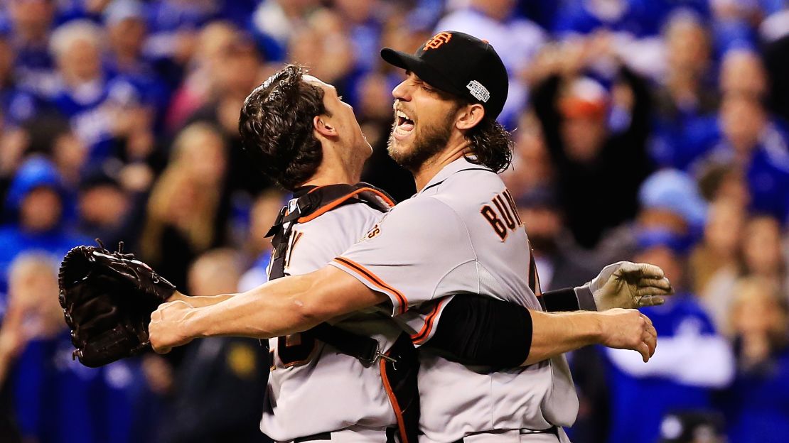 Buster Posey #28 and Madison Bumgarner #40 of the San Francisco Giants celebrate after defeating the Kansas City Royals to win Game Seven of the 2014 World Series by a score of 3-2 at Kauffman Stadium on October 29, 2014 in Kansas City, Missouri. 