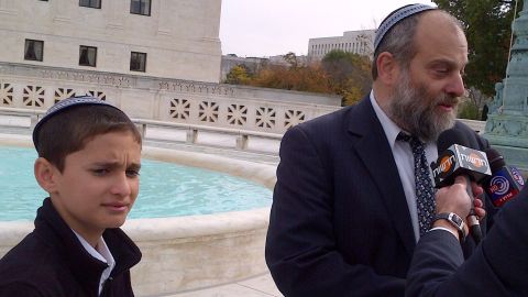 Menachem Zivotofsky, 12, and his father, Ari, are at the U.S. Supreme Court after oral arguments Monday.