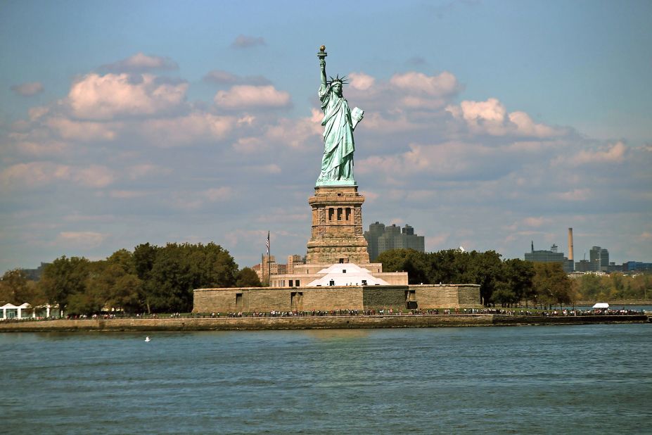 Circle Line Sightseeing cruises pass close to Lady Liberty before heading under the Brooklyn and Manhattan bridges.