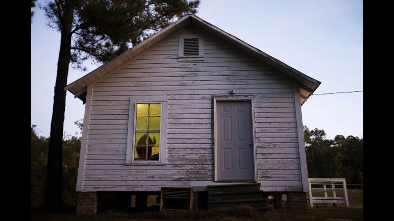 A poll manager is sworn in before the polls open at the old Hoggards Mill Courthouse in Newton, Georgia.