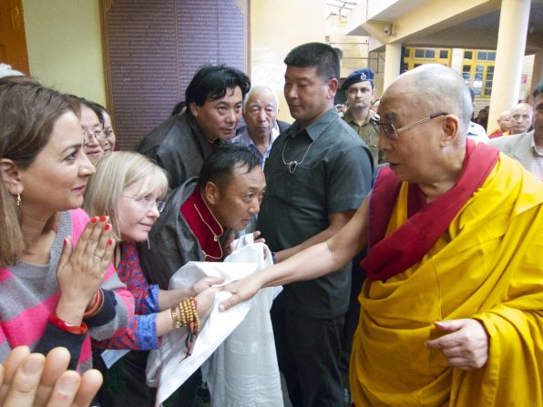 For some, a handshake with the Dalai Lama is an experience of serenity followed by giddy childlike joy.